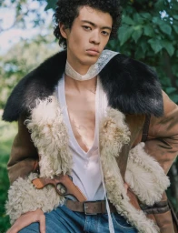 Model wearing a shearling coat and lace choker posing outdoors for Flaunt magazine under natural light.