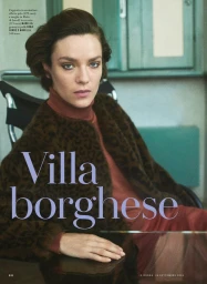 Model Lisa Louis Fratani in a leopard print jacket and turtleneck seated indoors for iO Donna editorial
