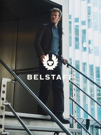 Model wearing a dark leather jacket on metal exterior stairs for Belstaff FW26 campaign