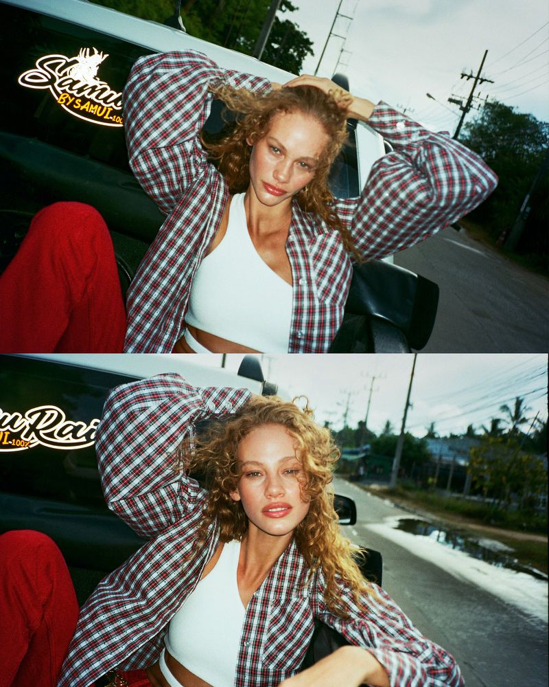 Model with curly hair in a plaid shirt posing outdoors near a car for Vogue Netherlands, photographed by Jorin Koers.