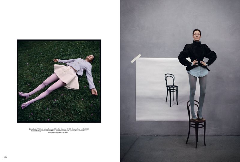 Vicky Krieps standing on a wooden chair against a grey studio wall for Vogue Germany ALLES ANDERS editorial