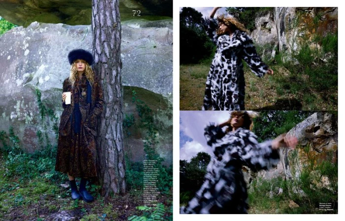 Model Liv Walters in a printed coat and faux fur hat standing by a tree in a rocky forest setting for Les Echos