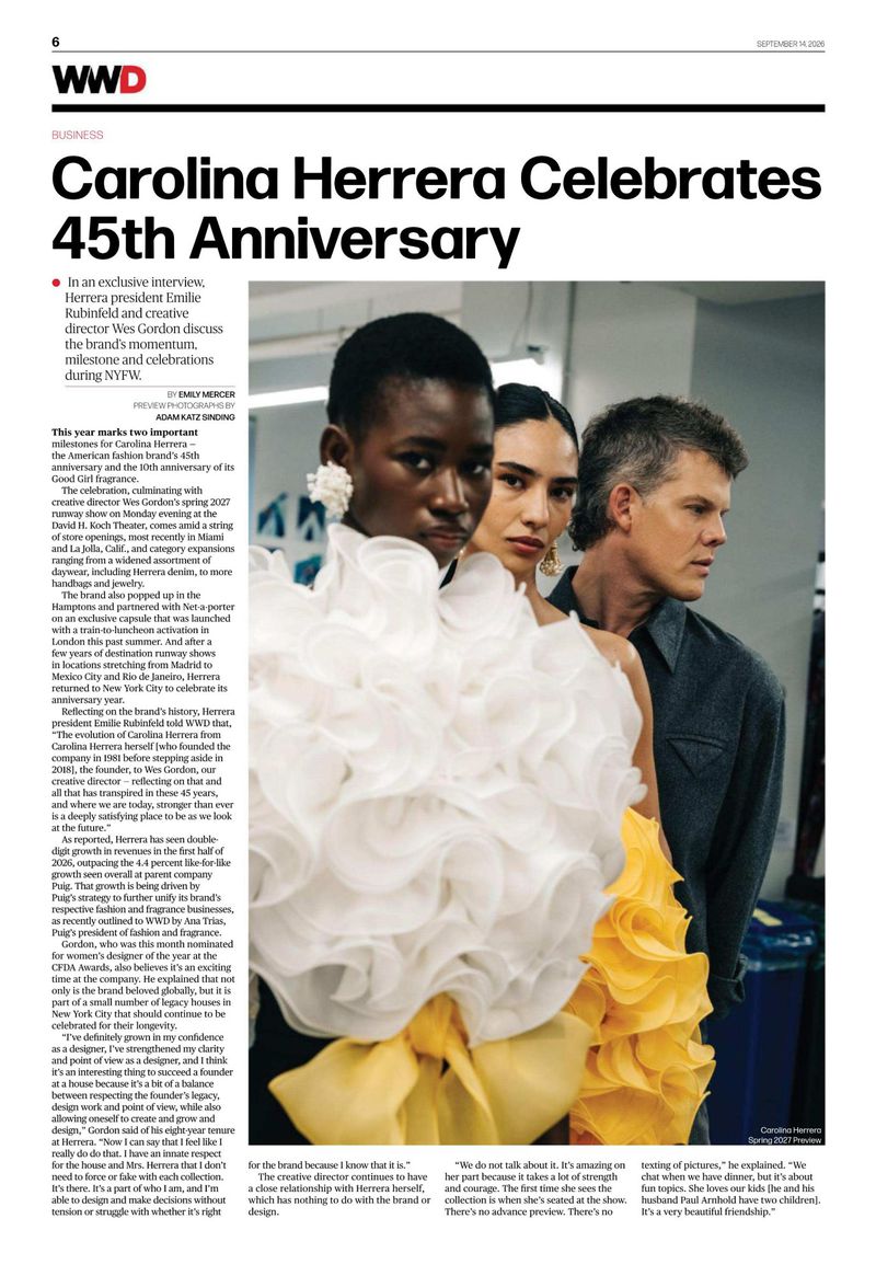 Models and designer Wes Gordon posing together in an indoor setting for WWD magazine feature coverage
