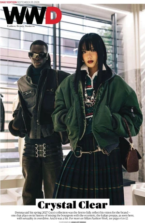 Two models posing indoors for WWD cover featuring green bomber jacket, pleated plaid skirt, and dark leather jacket.