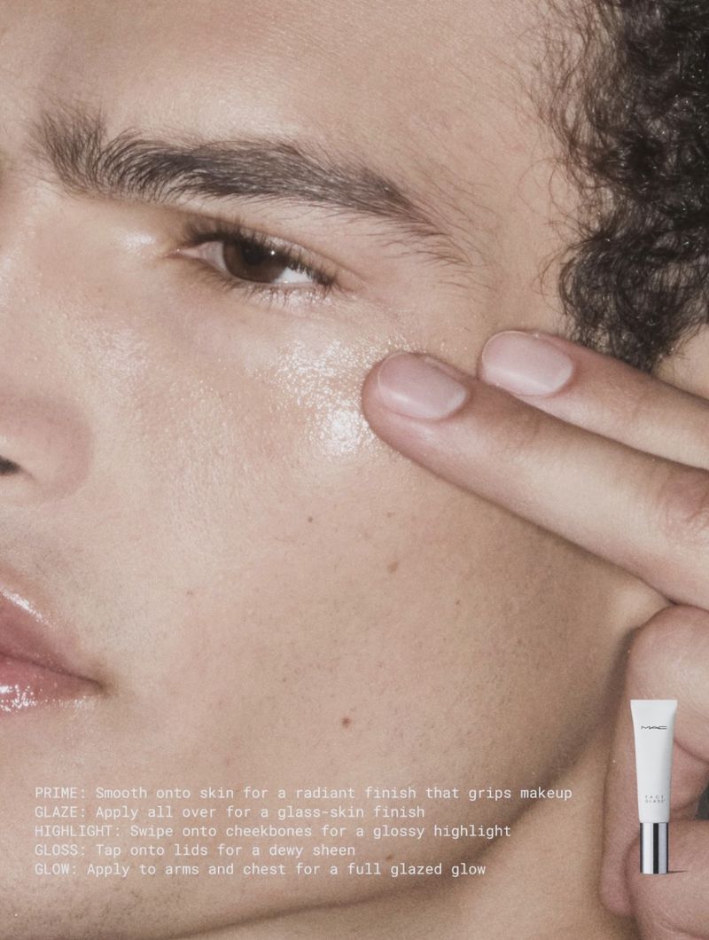 Close-up portrait of a male model applying MAC Cosmetics product to cheekbone for the Lustreglass 2026 Campaign