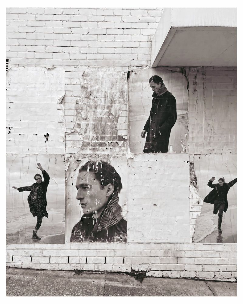 Black and white paste-up posters of a male model on a distressed white brick wall for DISTRETTO12 Autumn 2026 Campaign.