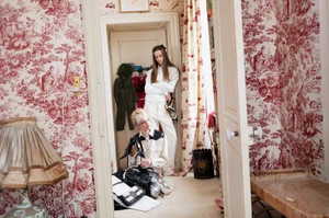 Two female models in an interior with red toile de Jouy wallpaper for AnOther Magazine
