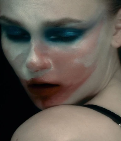 Close up beauty portrait of a woman with dramatic blue eyeshadow and artistic face paint for Harper's Bazaar Brazil