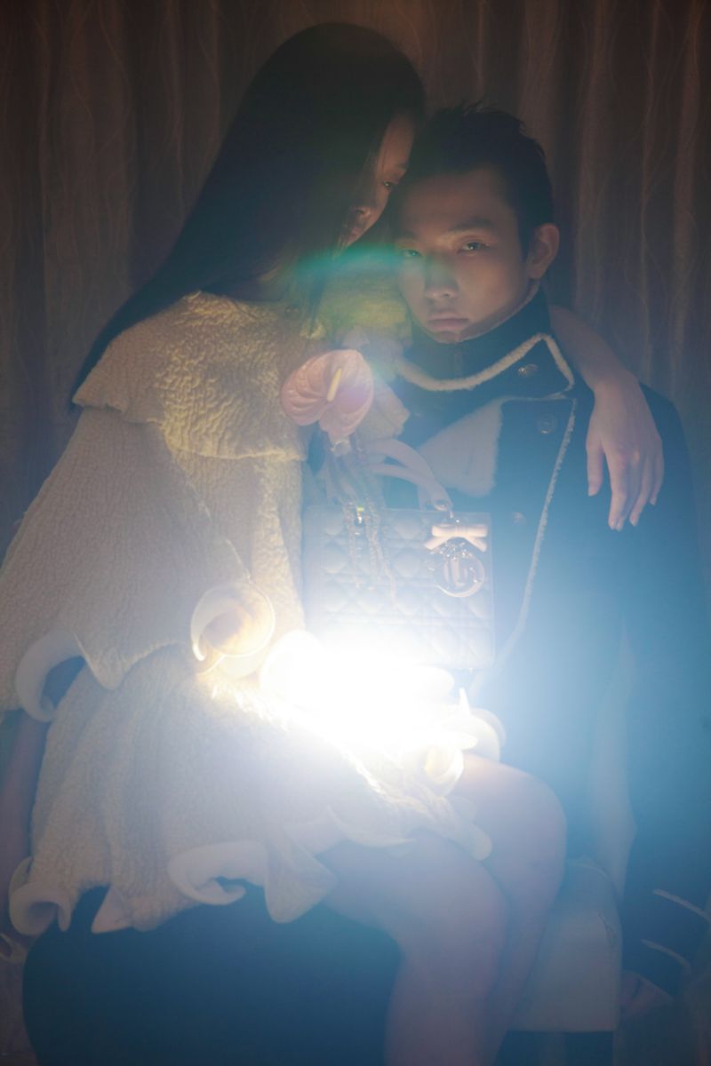 Two models posing together with a bright central light flare and handbag for DNA Magazine Mexico