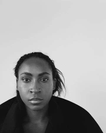 Portrait of Coco Gauff wearing a black garment against a plain white background for The Gentlewoman.