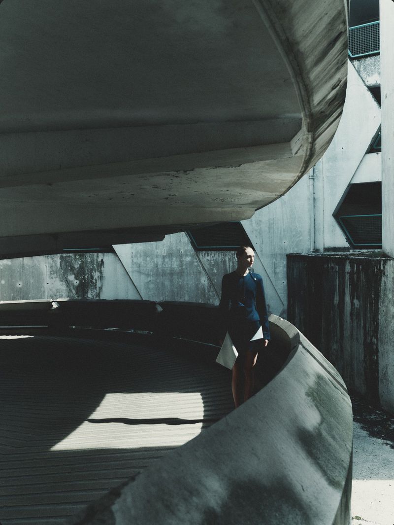 Model Daga Ziober standing within a brutalist concrete parking structure for Séduction Magazine editorial by Gus&Lo