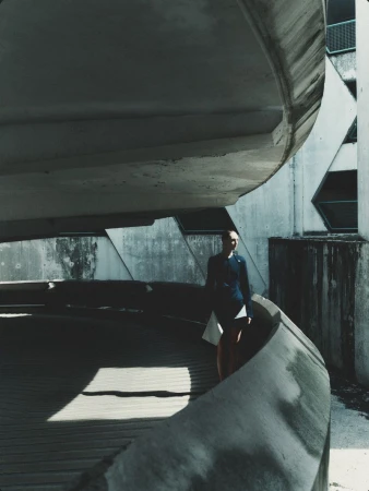 Model Daga Ziober standing within a brutalist concrete parking structure for Séduction Magazine editorial by Gus&Lo