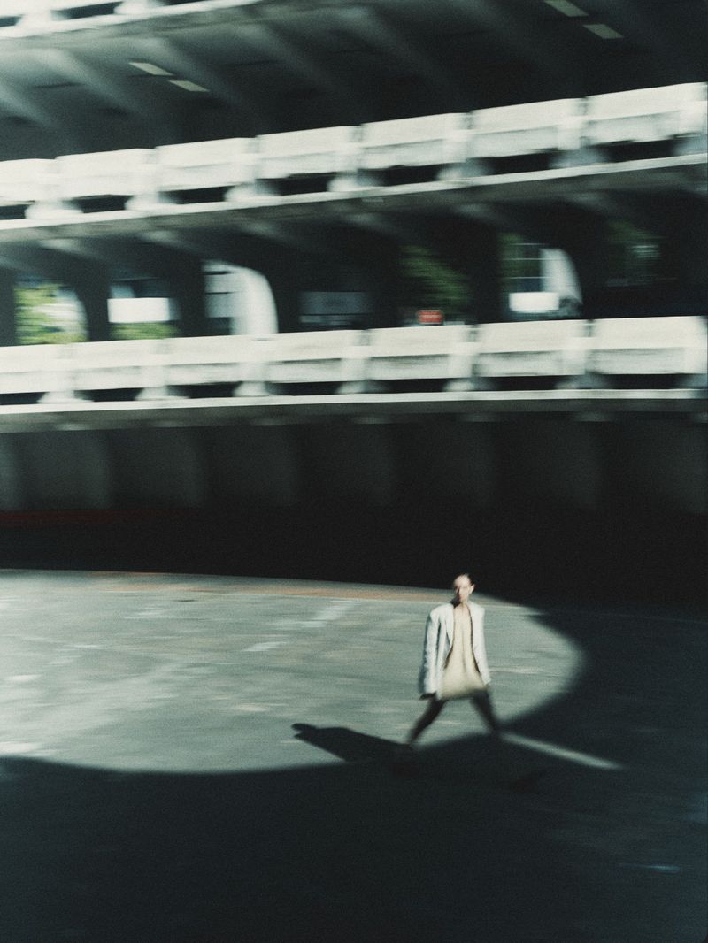Model Daga Ziober walking in a vast concrete parking structure for Seduction Magazine by GusandLo