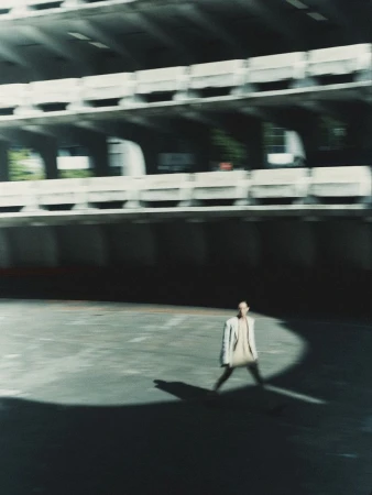 Model Daga Ziober walking in a vast concrete parking structure for Seduction Magazine by GusandLo
