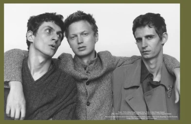 Three male models posing together in textured wool knitwear against a plain light studio background for Harper's Bazaar France Homme.