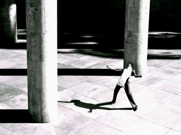 Model Alton Mason posing dynamically amidst monumental stone pillars for Elle Men Brasil, photographed by Lufre.