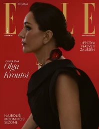 Profile portrait of a woman wearing a black dress and gold choker against a bold red background for Elle Slovenia magazine