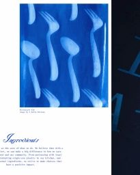 Cyanotype photographic print featuring a pattern of cutlery silhouettes including spoons and forks on blue paper.