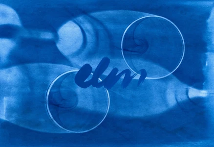 Cyanotype blue print featuring abstract circular rings and handwritten script branding for restaurant Elm