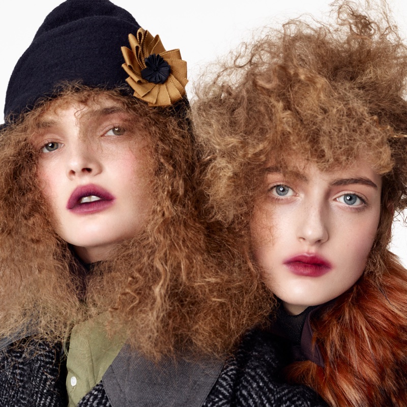 Two female models posing in textured winter coats and hats against a plain white background for Zara Re-form project.