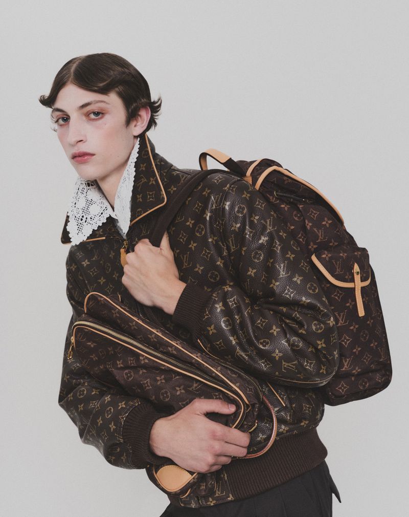 Model wearing a monogram leather jacket with a matching backpack for HERO Magazine photographed by Davey Sutton.