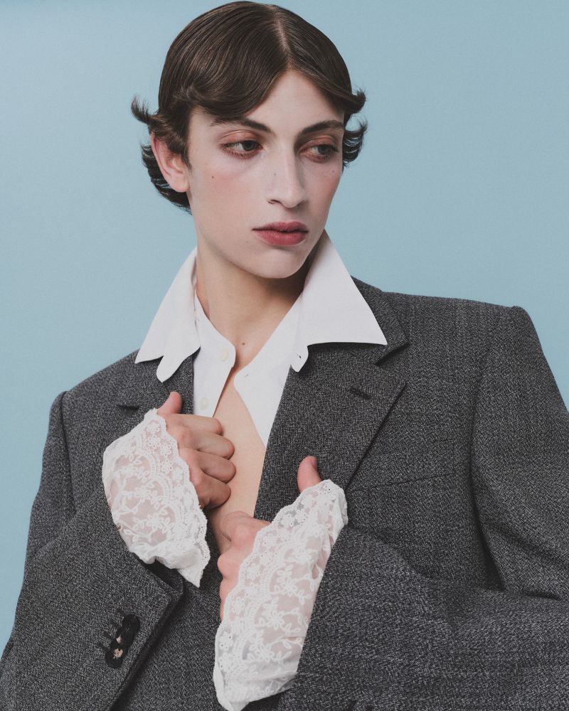 Model in grey blazer and white shirt with lace cuffs for HERO Magazine by photographer Davey Sutton