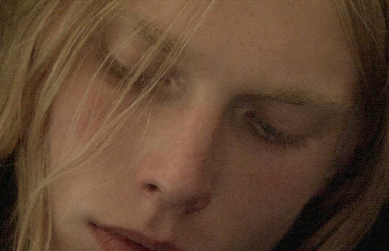 Close-up portrait of a model with blonde hair and closed eyes for HERO Magazine project Trinkets shot by Richard Dowker.