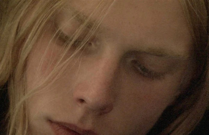 Close-up portrait of a model with blonde hair and closed eyes for HERO Magazine project Trinkets shot by Richard Dowker.