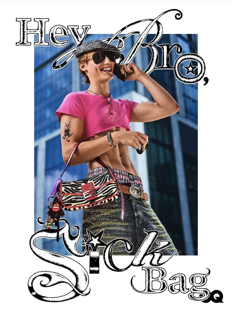 Model in pink crop top and zebra print handbag talking on a phone against an office building background