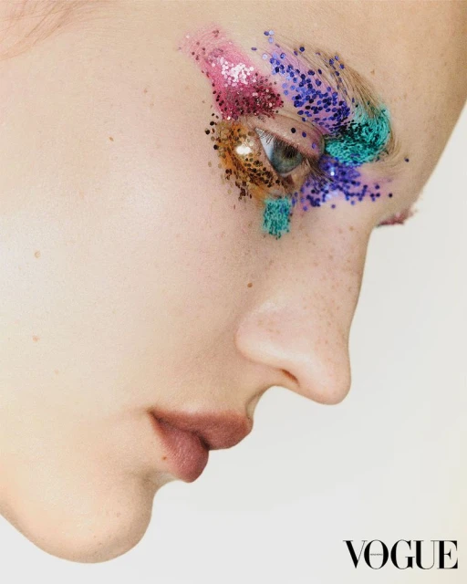 Close-up profile portrait of a model with vibrant glitter eye makeup for Vogue Hong Kong