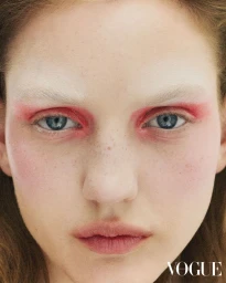 Close-up beauty portrait of a woman with vibrant pink eyeshadow and freckles photographed for Vogue Hong Kong.