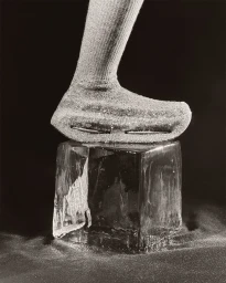Close-up of a sneaker on a clear ice block against a dark background for the Nike Atelier project.