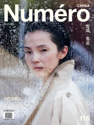 Model Xiao Wen Ju seen through a rain-streaked window wearing a trench coat for Numero China editorial