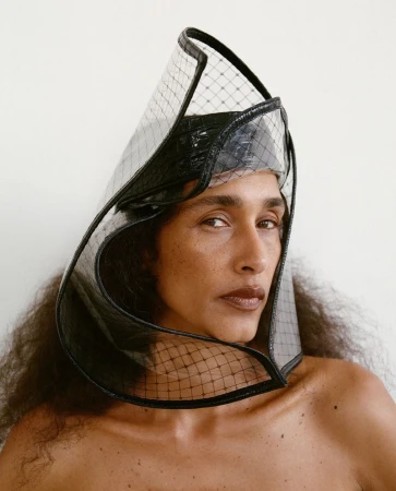 Model Shani Feldman wearing a structured translucent headpiece and black headwrap for Vogue Czechoslovakia by Gosia Turczynska.