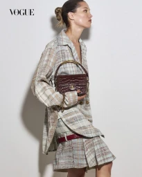 Model Hana Jirickova in plaid jacket holding dark red handbag for Vogue Thailand