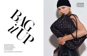 Model Hana Jirickova wearing a black beanie and holding a large woven leather handbag for Vogue Thailand.