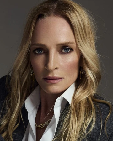 Close-up portrait of Uma Thurman wearing a white shirt and dark jacket against a grey background.