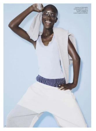 Model Maty Fall wearing tinted glasses and athletic attire in front of a blue background for Vogue Espana