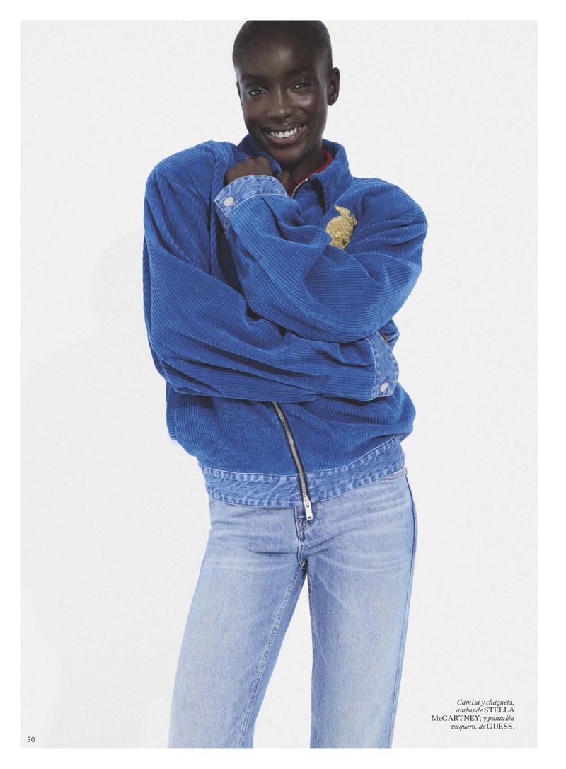 Model Maty Fall wearing a blue corduroy jacket and light wash jeans against a white seamless background for Vogue Espana.