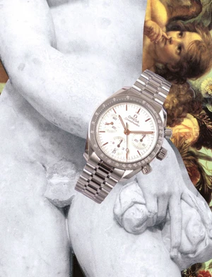 Omega Speedmaster chronograph watch with a white dial and metallic bracelet collaged over classical marble sculpture fragments.