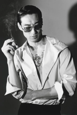 Man wearing sunglasses and a button-down shirt smoking a cigar in a black and white editorial portrait for HERO Magazine