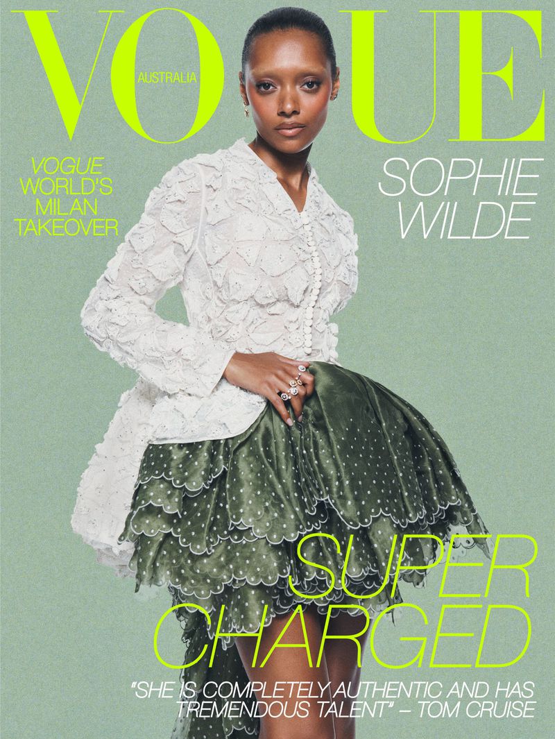 Actor Sophie Wilde on Vogue Australia cover wearing a white patterned jacket and green ruffled skirt against soft green backdrop