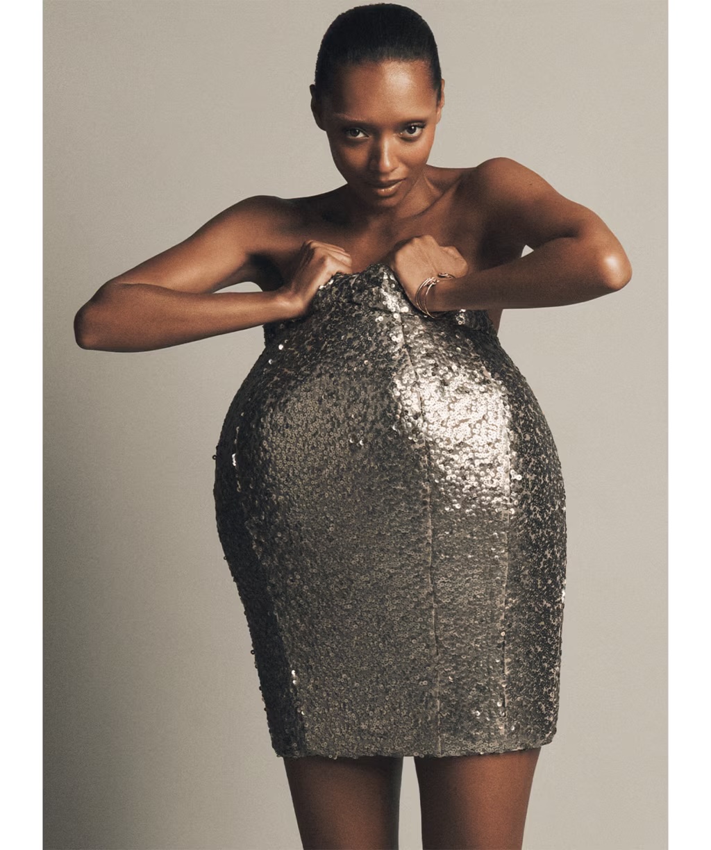 Model wearing a structured silver sequin dress against a plain grey backdrop for Vogue Australia October 2026