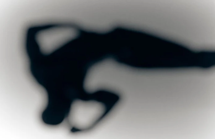 Abstract heavy silhouette of a person in motion against a soft gradient background