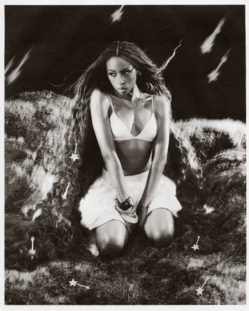 Black-and-white portrait of Ravyn Lenae kneeling on a textured surface under falling shooting stars for Teen Vogue.