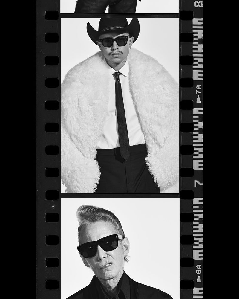 Black and white close-up of two adult males in formal wear and sunglasses shown within a filmstrip-style border in a vertical portrait.