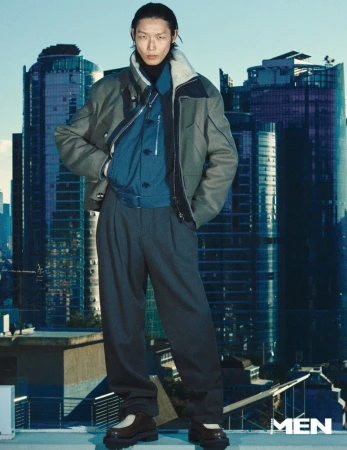 Model Xu Meen wearing a layered jacket and trousers against a city skyline for Noblesse Korea