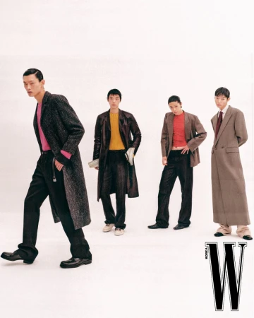Four male models posing in tailored coats and trousers against a bright white studio background for W Korea editorial.