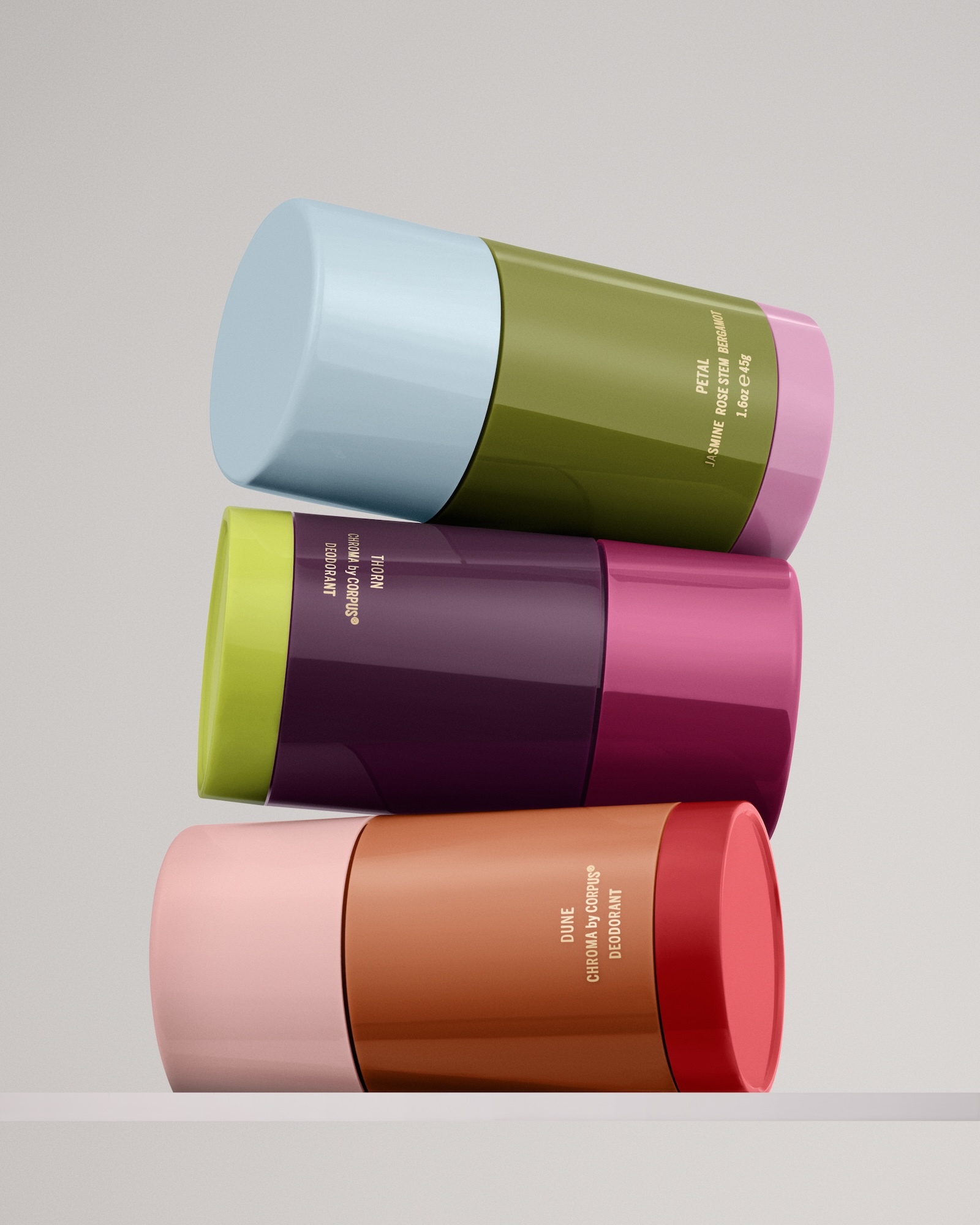 Three cylindrical deodorant containers stacked horizontally in a column against a plain neutral background.