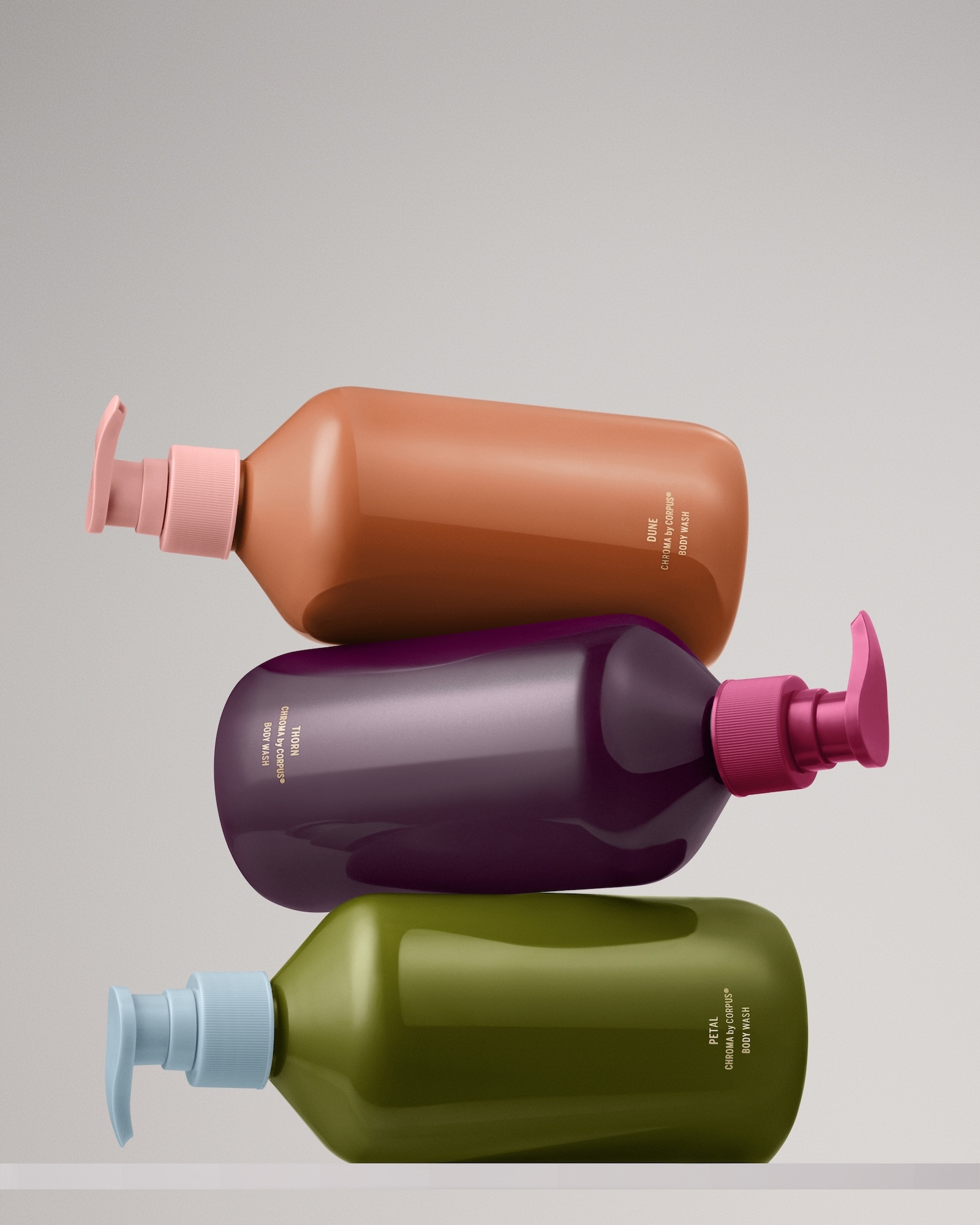 Three stacked colorful pump bottles with body wash for Target brand identity design by Marc Atlan